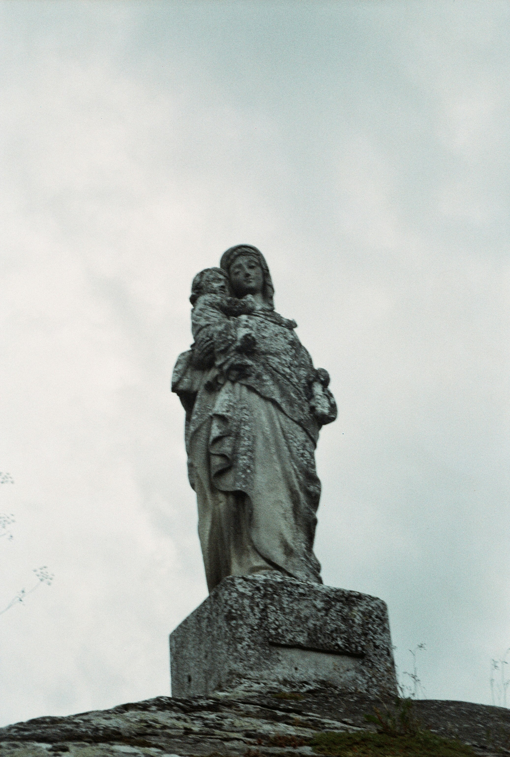 gray concrete statue under white sky during daytime